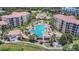 Aerial view of a stylish community pool surrounded by palm trees and ample seating, perfect for relaxation at 8601 Worldquest Blvd # 3404, Orlando, FL 32821