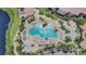 Aerial shot of a uniquely shaped pool surrounded by palm trees, lounge chairs, and manicured landscaping at 8601 Worldquest Blvd # 3404, Orlando, FL 32821