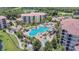 Aerial view of a sparkling blue pool area with palm trees and plenty of space for lounging and recreation at 8601 Worldquest Blvd # 3404, Orlando, FL 32821