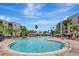 Resort-style pool area with lush landscaping and ample lounge seating at 8601 Worldquest Blvd # 3404, Orlando, FL 32821
