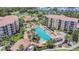 Stunning aerial view of a large community pool with surrounding condos, lush greenery, and resort-style amenities at 8601 Worldquest Blvd # 3404, Orlando, FL 32821