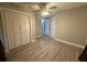 Bedroom featuring new laminate flooring, ceiling fan, and closet at 5641 Nw 55Th Ave, Ocala, FL 34482