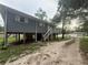 Back exterior view of a home featuring a deck and stilt foundation at 5641 Nw 55Th Ave, Ocala, FL 34482