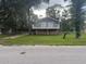 Charming two-story home featuring a well-maintained lawn and mature trees at 5641 Nw 55Th Ave, Ocala, FL 34482