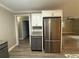 Kitchen featuring stainless refrigerator, granite countertop and updated cabinets at 5641 Nw 55Th Ave, Ocala, FL 34482