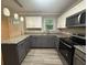 Updated kitchen with stainless steel appliances, gray cabinetry, and granite countertops at 5641 Nw 55Th Ave, Ocala, FL 34482