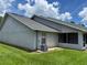 Exterior side view of the home with a screen porch and well-maintained lawn at 888 W Stuart St, Bartow, FL 33830