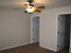 Bedroom with carpet flooring, ceiling fan and closets at 888 W Stuart St, Bartow, FL 33830