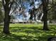 Exterior view showcases homes with lush green lawns and mature trees creating a serene neighborhood setting at 888 W Stuart St, Bartow, FL 33830