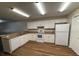 Bright kitchen with white cabinets, modern appliances, and laminate countertops at 888 W Stuart St, Bartow, FL 33830