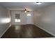 Spacious living room with wood floors, ceiling fan and natural light at 888 W Stuart St, Bartow, FL 33830