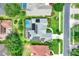 Aerial view of a house with solar panels and a screened-in pool surrounded by green lawns and neighborhood streets at 17426 Tailfeather Ct, Clermont, FL 34711