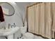 Bathroom with a pedestal sink, a decorative shower curtain, and brushed nickel fixtures at 17426 Tailfeather Ct, Clermont, FL 34711