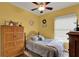 Comfortable bedroom featuring soft colors, a ceiling fan, and ample natural light at 17426 Tailfeather Ct, Clermont, FL 34711