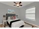 Bedroom with a gray headboard bed, neutral walls, and a bright window with blinds at 17426 Tailfeather Ct, Clermont, FL 34711