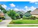 Charming single-story home with lush landscaping and a well-manicured lawn at 17426 Tailfeather Ct, Clermont, FL 34711