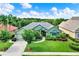 Landscaped front yard of a lovely single-Gathering home with a well manicured lawn and paved driveway at 17426 Tailfeather Ct, Clermont, FL 34711