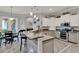 Modern kitchen with granite countertops and stainless steel appliances at 17426 Tailfeather Ct, Clermont, FL 34711
