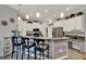 Eat-in kitchen with granite countertops, stainless steel appliances, and breakfast bar at 17426 Tailfeather Ct, Clermont, FL 34711