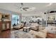 Open-concept living space with hardwood floors, great natural light, and adjoined to the kitchen at 17426 Tailfeather Ct, Clermont, FL 34711