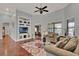 Bright living room featuring built-in shelving and hardwood flooring at 17426 Tailfeather Ct, Clermont, FL 34711