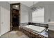 An elegant main bathroom features a walk-in shower, soaking tub, and neutral paint at 17426 Tailfeather Ct, Clermont, FL 34711