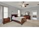 A large, bright, and airy main bedroom features a ceiling fan and an ensuite bathroom with a tub at 17426 Tailfeather Ct, Clermont, FL 34711