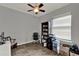 Bright room with a ceiling fan, large window, and organized bookshelf at 17426 Tailfeather Ct, Clermont, FL 34711