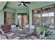 Relaxing covered patio with a ceiling fan, a glass top table, and seating for six people at 17426 Tailfeather Ct, Clermont, FL 34711
