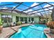 A beautiful in-ground pool is surrounded by a screened enclosure with covered patio and an outdoor bar at 17426 Tailfeather Ct, Clermont, FL 34711