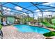 Inviting in-ground pool with brick paver surround, a covered patio with a bar, and a screened enclosure at 17426 Tailfeather Ct, Clermont, FL 34711