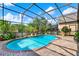 Private pool with lush landscaping, brick pavers, and tranquil views creating a serene oasis at 17426 Tailfeather Ct, Clermont, FL 34711