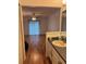 Bathroom with a wood floor, neutral walls, sink and vanity area, a ceiling fan, and a glimpse into the spacious bedroom at 5523 Westview Dr, Orlando, FL 32810