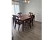 Formal dining room with wood flooring, a chandelier, and an elegant wood table with upholstered chairs at 5523 Westview Dr, Orlando, FL 32810