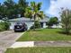 Charming single-story home with a well-maintained lawn and mature landscaping, and a modern SUV parked in the driveway at 5523 Westview Dr, Orlando, FL 32810