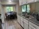 Well-lit kitchen with white cabinets, stainless steel appliances, a double sink, and a cozy breakfast nook with a view at 5523 Westview Dr, Orlando, FL 32810