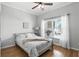 Bright bedroom with hardwood floors, a cozy bed, and natural light, creating a serene and comfortable space at 1485 Waukon Cir, Casselberry, FL 32707