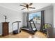 Comfortable bedroom featuring a treadmill, and ample natural light, providing a versatile and inviting atmosphere at 1485 Waukon Cir, Casselberry, FL 32707