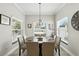 Formal dining room bathed in natural light, featuring an elegant chandelier and views to the outside at 1485 Waukon Cir, Casselberry, FL 32707