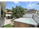 Relax in this backyard featuring a hot tub, table and chairs under a shade tree, and manicured landscaping at 1485 Waukon Cir, Casselberry, FL 32707