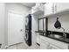 Modern laundry room with stacked washer and dryer, ample storage, and a sleek sink area for added convenience at 1485 Waukon Cir, Casselberry, FL 32707