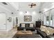 Inviting living room featuring a high ceiling, a leather sofa, and a large picture window providing ample natural light at 1485 Waukon Cir, Casselberry, FL 32707