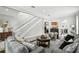 Bright living room featuring neutral walls, hardwood floors, a fireplace, comfortable seating, and staircase to the upper level at 1485 Waukon Cir, Casselberry, FL 32707