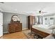 Cozy main bedroom featuring a ceiling fan, a hardwood floor, a wooden dresser and an access door to the outside at 1485 Waukon Cir, Casselberry, FL 32707