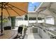 Enjoy outdoor dining in this backyard featuring a built-in kitchen under a covered patio at 1485 Waukon Cir, Casselberry, FL 32707