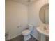 Modern half-bathroom featuring a pedestal sink, updated fixture, modern mirror, and toilet at 938 Mansfield Rd, Tavares, FL 32778
