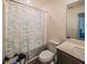 Bathroom features modern fixtures, a shower with a curtain, and neutral tones at 938 Mansfield Rd, Tavares, FL 32778