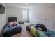 Bedroom featuring two beds, window, and neutral walls, offering a flexible living space at 938 Mansfield Rd, Tavares, FL 32778