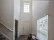 Bright foyer with soaring ceilings, a large window, staircase, and a convenient half-bathroom to the left at 938 Mansfield Rd, Tavares, FL 32778