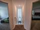 Upstairs hallway with bedrooms on either side, neutral colors, and natural light at 938 Mansfield Rd, Tavares, FL 32778